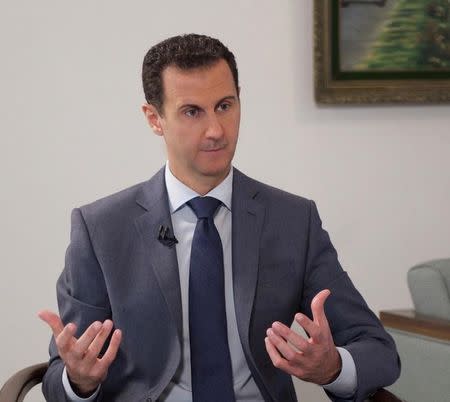 Syria's President Bashar al-Assad speaks during an interview with al-Watan newspaper in Damascus, Syria, in this handout picture provided by SANA on December 8, 2016. SANA/Handout via REUTERS