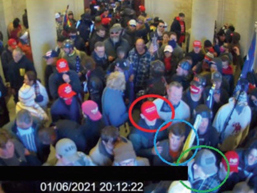 In this image from U.S. Capitol Police video, released and annotated by the Justice Department in the Statement of Facts supporting an arrest warrant, Joshua Abate, circled in green, Micah Coomer, circled in red, and Dodge Dale Hellonen, circled in blue, appear inside the U.S. Capitol on Jan. 6, 2021, in Washington. Abate and Hellonen, who were active-duty members of the Marines Corps when they stormed the U.S. Capitol, pleaded guilty on Monday, June 12, 2023, to riot-related criminal charges. Coomer, who was an active-duty Marine, pleaded guilty to the same misdemeanor charge in May.