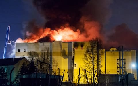 The Zimnyaya Vishnya shopping centre engulfed by flames - Credit: Danil Aikin/TASS via Getty