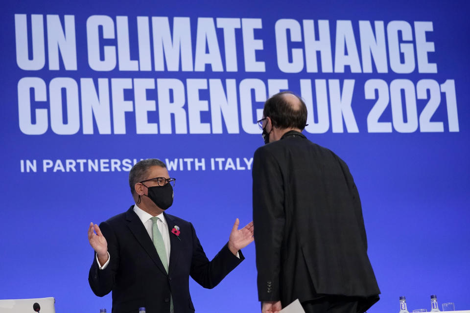 Alok Sharma, left, President of the COP26 summit attends a stocktaking plenary session at the COP26 U.N. Climate Summit, in Glasgow, Scotland, Saturday, Nov. 13, 2021. Going into overtime, negotiators at U.N. climate talks in Glasgow are still trying to find common ground on phasing out coal, when nations need to update their emission-cutting pledges and, especially, on money. (AP Photo/Alberto Pezzali)