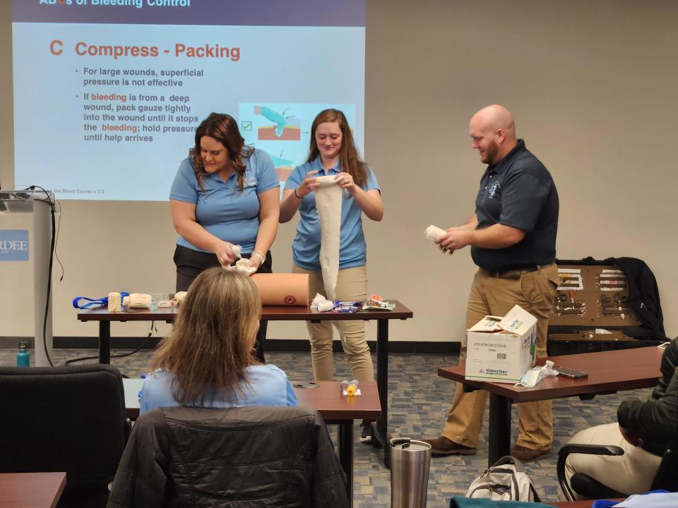 Pardee UNC Health Sports Medicine's Barb Speight and Sarah Warren practice compressing a wound.