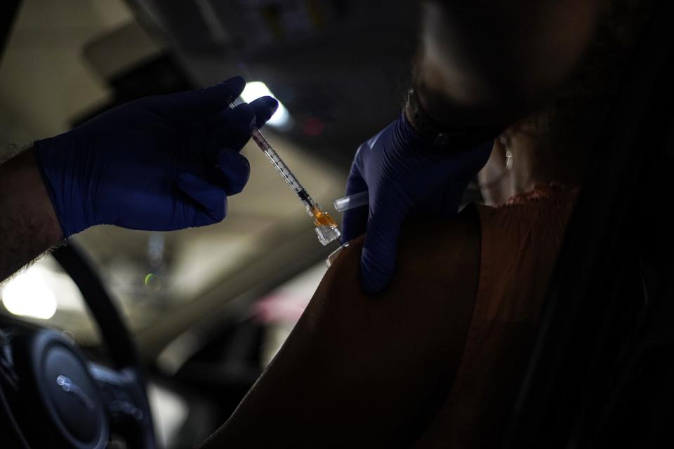 A patient receives the Moderna vaccine at the TCF Center in Detroit on Monday, Aug. 23, 2021.