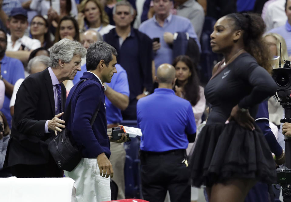 Chair umpire Carlos Ramos, second from left, is lead off the court by referee Brian Earley after Naomi Osaka, of Japan, defeated Serena Williams in the women's final of the U.S. Open tennis tournament, Saturday, Sept. 8, 2018, in New York. (AP Photo/Julio Cortez)