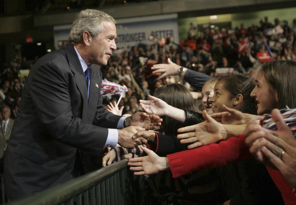 FILE - President George W. Bush shakes hands with supporters as he is introduced at a campaign rally Nov. 1, 2004, in Sioux City, Iowa. (AP Photo/Pablo Martinez Monsivais, File)