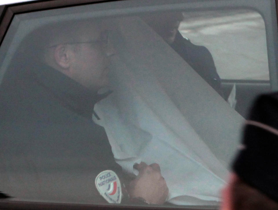 A police car transports Manuel Noriega from a Paris courthouse, 2010