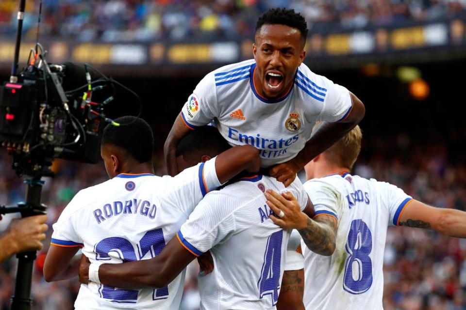 Real Madrid’s David Alaba, down centre, celebrates with team-mates after scoring his sides first goal during El Clasico against Barcelona (Joan Monfort/AP) (AP)