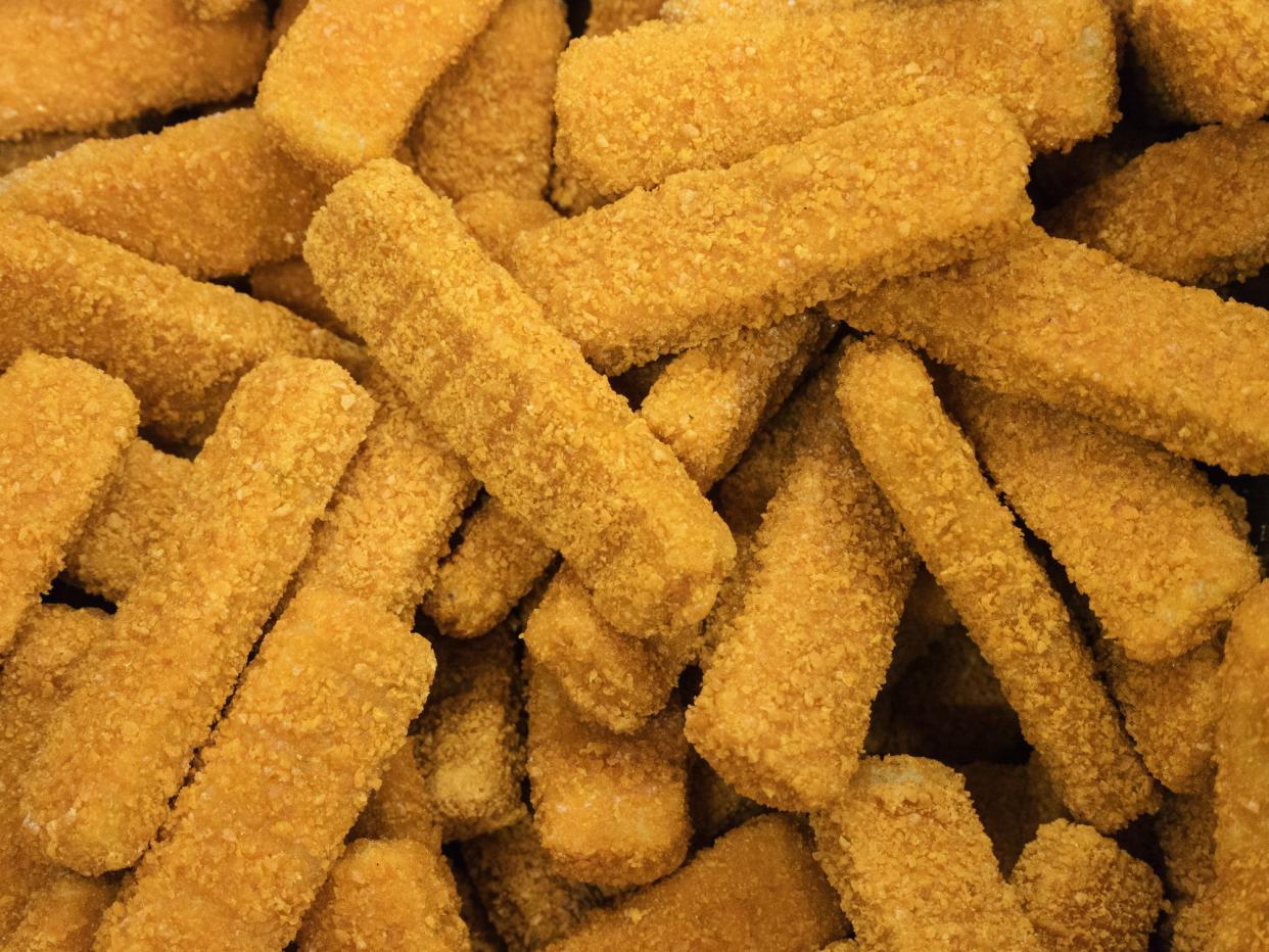 Frozen chicken sticks breaded in the freezer in the store