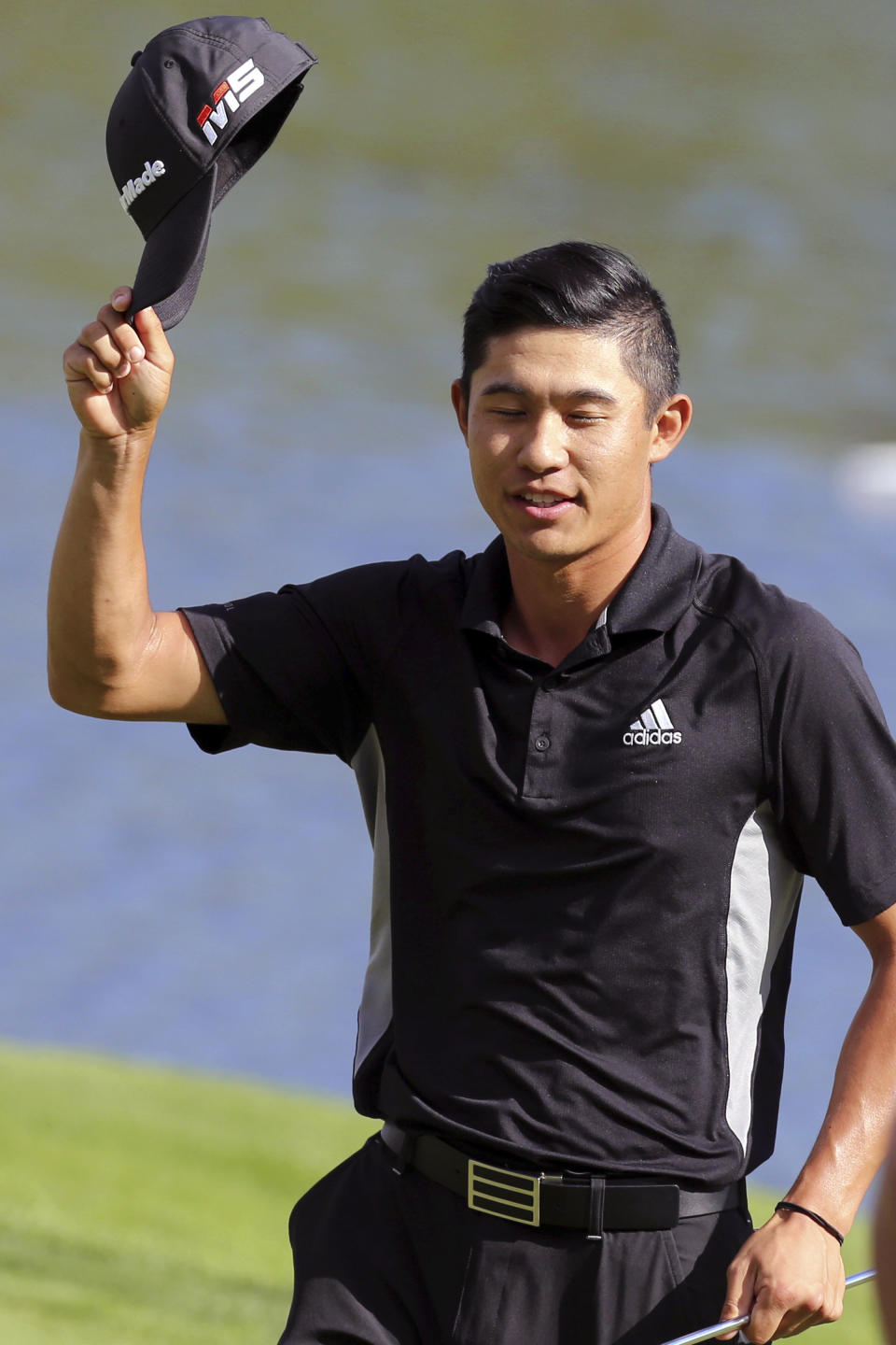 Collin Morikawa tips his cap to the gallery after sinking a birdie putt on the 18th Green during the final round in the Barracuda Championship golf tournament at Montreux Golf & Country Club in Reno, Nev., Sunday, July 28, 2019. (AP Photo/Lance Iversen)