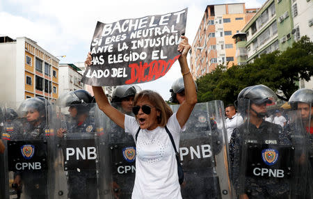 Opposition supporters take part in a rally against Venezuelan President Nicolas Maduro's government in Caracas, Venezuela March 9, 2019. Placard reads "Bachelet, if you are neutral towards the injustice, you have chosen the side of the dictatorship". REUTERS/Carlos Garcia Rawlins