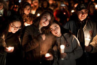 Caprice Cortez, Faith Goodsell, Autumn Barton and Mykaylla Darrow, all teammates on the Grantsville High School girls soccer team that Alexis Haynie played on, stand together at a candlelight vigil for the Haynie family at City Park in Grantsville, Utah, Monday, Jan. 20, 2020. Police say four members of the Haynie family were killed and one injured after being shot by a teenage family member on Jan. 17. (Spenser Heaps/The Deseret News via AP)