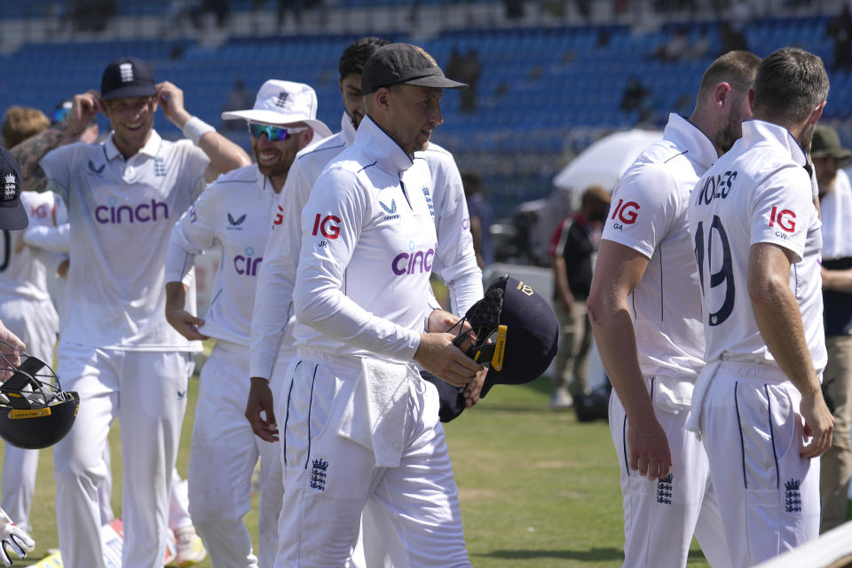 England's Joe Root, center, and teammates walk off the field after winning the first test cricket match against Pakistan, in Multan, Pakistan, Friday, Oct. 11, 2024. (AP Photo/Anjum Naveed)