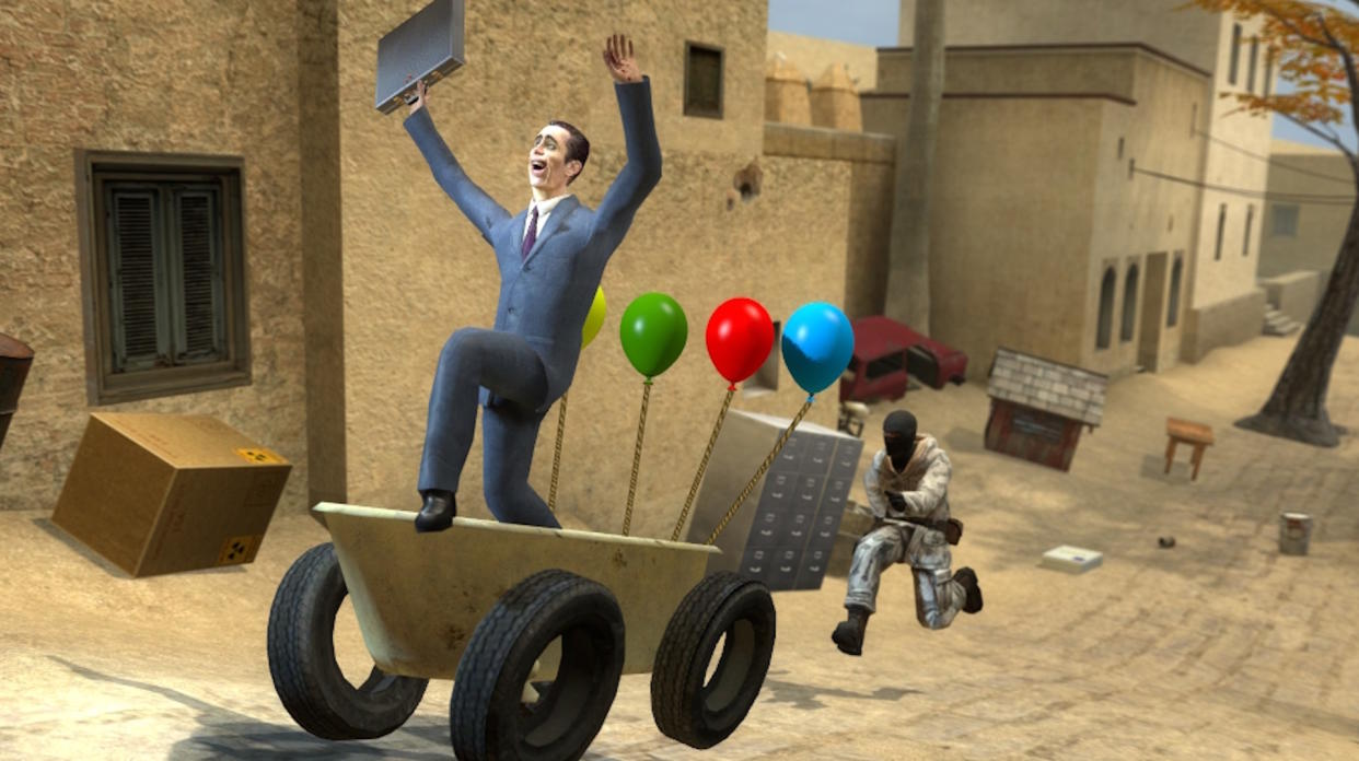  Garry's Mod screen - G-Man riding a balloon-festooned cart with his hands held above his head while a Counter-Strike guy chases him. 