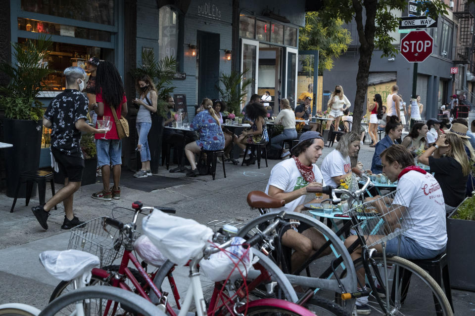 Customers dine outside Dudley's, Monday, June 22, 2020, in New York. New York City Mayor Bill de Blasio says he is delaying the planned resumption of indoor dining at restaurants in the city out of fear it would ignite a a spike in coronavirus infections. (AP Photo/John Minchillo)