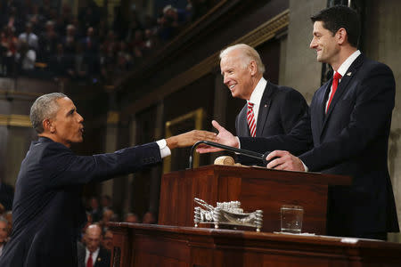 U.S. President Barack Obama (L) is welcomed by Vice President Joe Biden (C) and House Speaker Paul Ryan (R-WI) prior to delivering his final State of the Union address to a joint session of Congress in Washington January 12, 2016. REUTERS/Evan Vucci/Pool