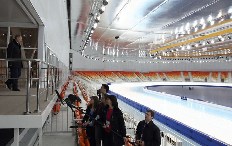 Russia's President Vladimir Putin (L) visits the Speed Skating centre 'Adler Arena' near the Black Sea city of Sochi, on February 7, 2013. A year before athletes converge on Sochi for the Winter Olympics, the Russian seaside city remains a vast construction site, with traffic choking the streets and locals bracing for another year of nonstop work to transform their landscape