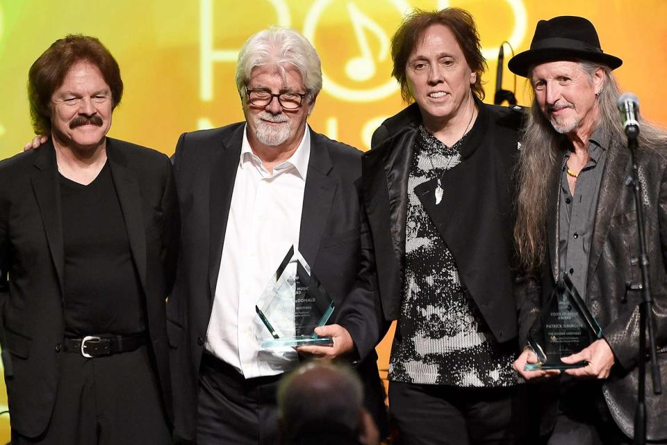 <p>Kevin Winter/Getty</p> Tom Johnston, Michael McDonald, John McFee and Patrick Simmons of the Doobie Brothers in Los Angeles in April 2015