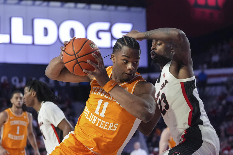 Tennessee forward Tobe Awaka (11) tries to get past Georgia forward Jalen DeLoach (23) during the half half of an NCAA college basketball game Saturday, Jan. 13, 2024, in Athens, Ga. (AP Photo/John Bazemore)