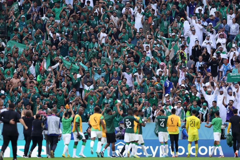 Saudi Arabia’s players celebrate with their fans at the  Lusail Stadium (Getty Images)