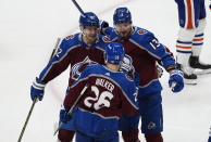 Colorado Avalanche right wing Valeri Nichushkin, back right, is congratulated by left wing Artturi Lehkonen, back left, and defenseman Sean Walker for a goal against the Edmonton Oilers during the first period of an NHL hockey game Thursday, April 18, 2024, in Denver. (AP Photo/David Zalubowski)