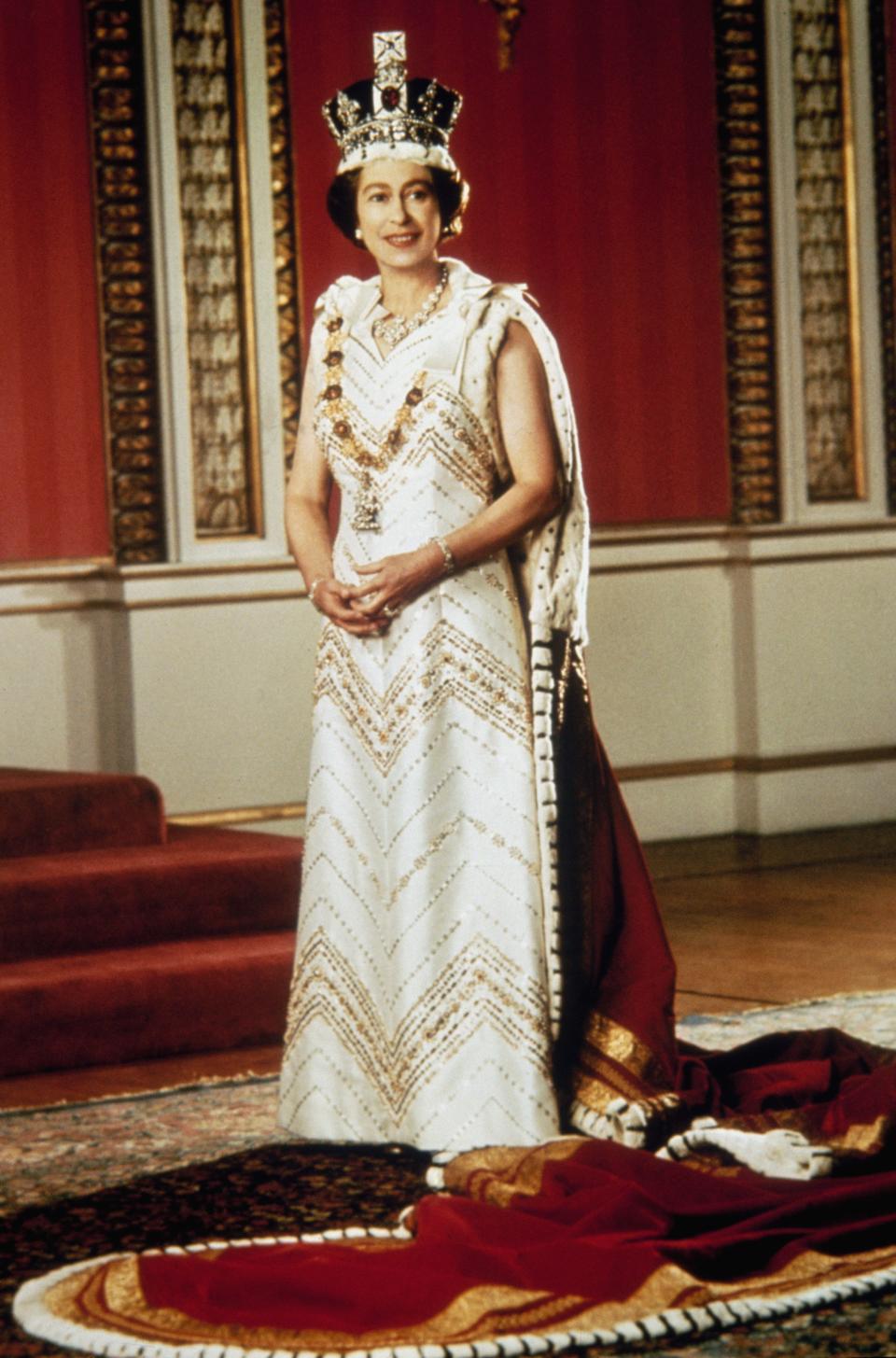 1977: Queen Elizabeth II poses for a silver jubilee portrait in the Throne Room of Buckingham Palace on Feb. 6, 1977.