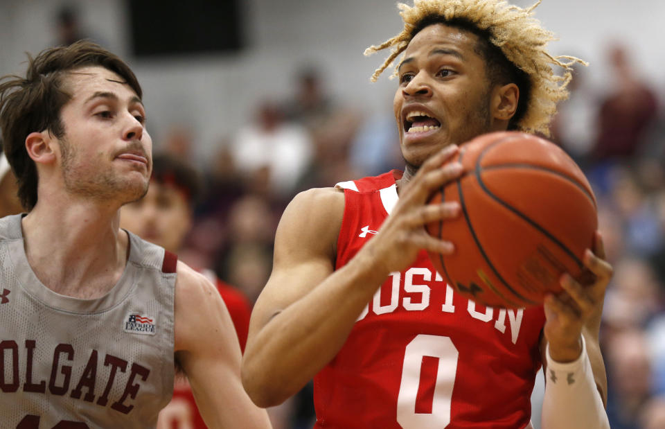 Boston University's Ethan Brittain-Watts, right, drives to the basket past Colgate's Jack Ferguson, left, in the first half of the NCAA Patriot League Conference basketball championship at Cotterell Court, Wednesday, March 11, 2020, in Hamilton, N.Y. (AP Photo/John Munson)