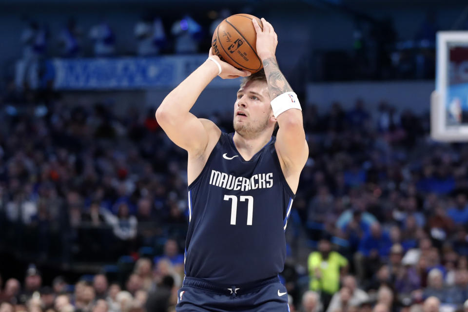 Dallas Mavericks forward Luka Doncic (77) attempts a three-pint basket in the first half of an NBA basketball game against the Cleveland Cavaliers in Dallas, Friday, Nov. 22, 2019. (AP Photo/Tony Gutierrez)