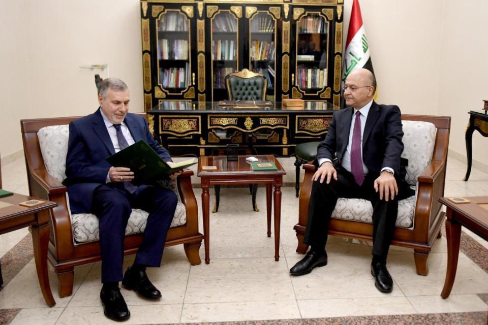 Iraqi President Barham Salih, right, instructs newly appointed Prime Minister Mohammed Allawi in Baghdad, Iraq, Saturday, Feb. 1, 2020. Former communications minister Mohammed Allawi was named prime minister-designate by rival Iraqi factions Saturday after weeks of political deadlock. (Iraqi Presidency Media Office, via AP)
