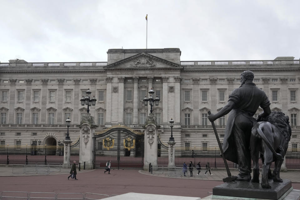 A general view of Buckingham Palace, one of the official residences of King Charles III, as pedestrians walk past in London, Tuesday, Feb. 6, 2024. Buckingham Palace announced Monday evening that the king has begun outpatient treatment for an undisclosed form of cancer. (AP Photo/Kin Cheung)