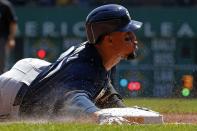 Milwaukee Brewers' Carlos Gomez slides into third with a triple during the third inning of a baseball game against the Pittsburgh Pirates in Pittsburgh Sunday, April 20, 2014. (AP Photo/Gene J. Puskar)