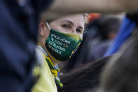 A supporter of Brazil's President Jair Bolsonaro, wearing a protective face mask with a message that reads in Portuguese: "Brazil above everything, God above everyone," during a rally of motorcycle enthusiasts who caravanned through the streets of the city, to show their support for Bolsonaro, in Sao Paulo, Brazil, Saturday, June 12, 2021. (AP Photo/Marcelo Chello)