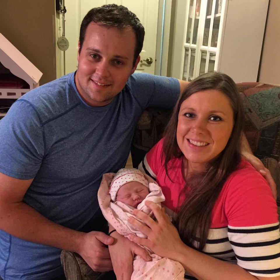 The Duggar family is sticking together. After news broke last week that TLC was canceling their hit show <em>19 Kids and Counting</em> in light of allegations of Josh Duggar molesting several underage girls, including his sisters, the 27-year-old former lobbyist is seen in a new video of his parents Jim Bob and Michelle celebrating their 31st wedding anniversary. In a video posted Tuesday, 50-year-old Jim Bob gives 48-year-old Michelle a ring made out of 19 birth stones to celebrate each one of their children. Josh is seen sitting on the couch at the 00:58 mark, with someone continuously calling out his name. He appears to be in good spirits, smiling while celebrating the occasion with family. <strong>WATCH: TLC Cancels '19 Kids and Counting'</strong> Josh's wife, Anna Duggar, is also seen sitting on the couch with him. The couple just announced the birth of their daughter, Meredith Grace, on Sunday. Meredith marks their fourth child together. Her older siblings include Mackynzie, 5, Michael, 4, and Marcus, 2. "Anna and Meredith are resting & doing well!" Josh Instagrammed on Sunday. Last month, the embattled family moved out of their Oxon Hill, Maryland home back to Arkansas, where the Duggar family is based. Sources told ET that Josh also hired Kate Gosselin's bodyguard, Steve Nield, following the molestation scandal. Despite the recent TLC cancellation and obvious stress on the family, Duggar patriarchs Jim Bob and Michelle couldn't be more in love. "The greatest blessing of my life was 31 years ago, on July 21, 1984 when Michelle married me," Jim Bob gushed about his wife on the family blog on Tuesday. "She is the virtuous woman that Proverbs 31 talks about. She is the ultimate wife and mother and I love her more and more each day. … She is an example to millions of women, her children rise up and call her blessed." Michelle is equally smitten. "Recently, when one of our daughters asked, 'Mom, what one quality should I look for in a future spouse?,' as I considered the answer, I realized what it is that I admire so much in you, Jim Bob," she wrote. "It is that you love and honor God and in humility you are open & transparent with me, simply put, humility and the fear of the lord." <strong> WATCH: Josh Duggar Noticeably Missing in New Family Photo Celebrating Amy's Engagement</strong> Watch the video below for more on Josh's new living arrangements.