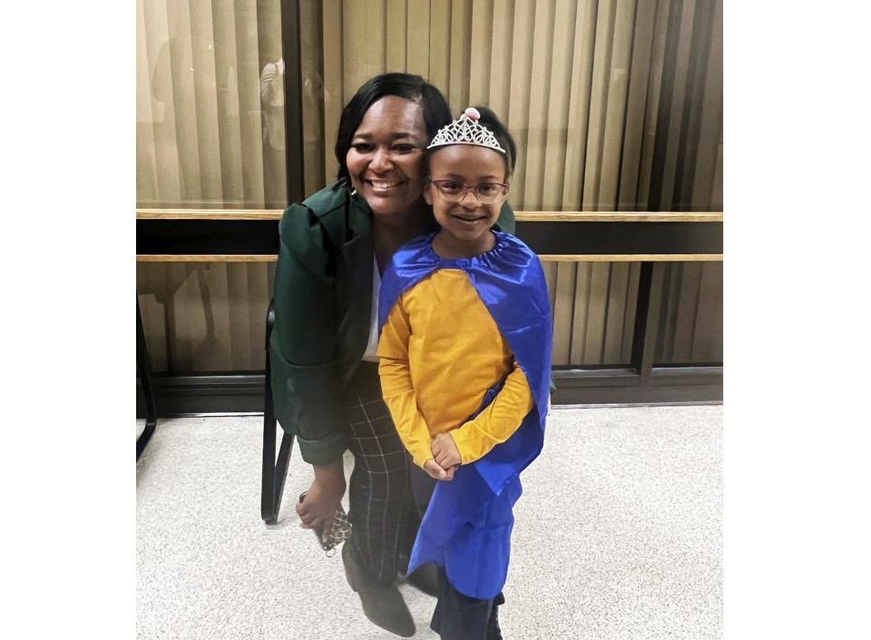 In this photo provided by Angie Craddieth, Bryanna Cook, right, a 6-year-old first grade student, is shown with Latonya Malone, a 911 dispatcher for Lowndes County, Miss., on Wednesday, Nov. 15, 2023, in Columbus, Miss.,