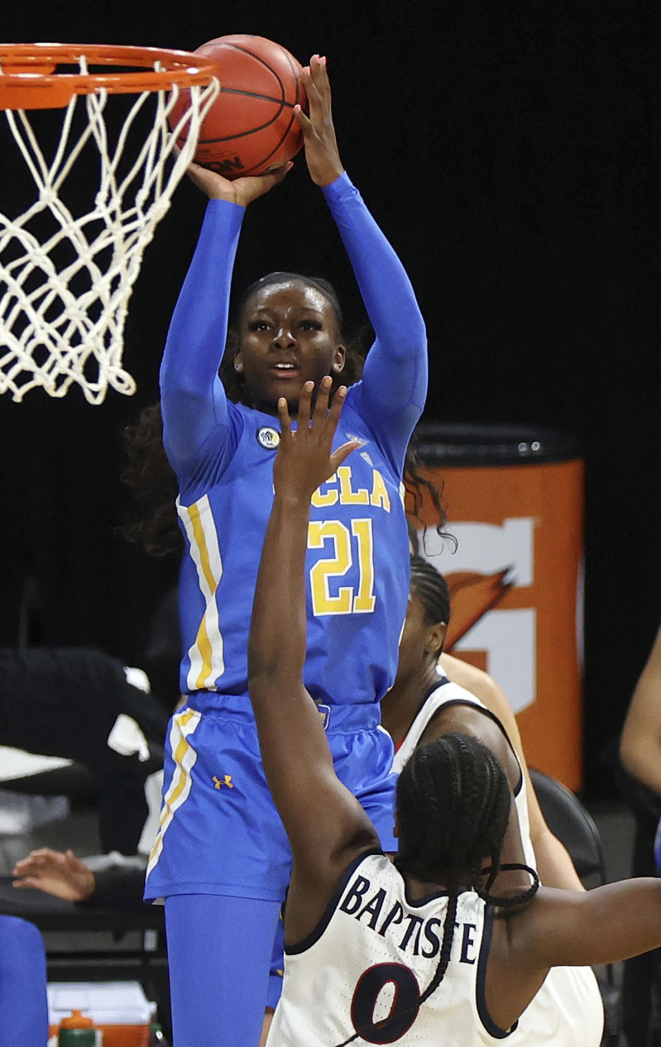 UCLA forward Michaela Onyenwere (21) shoots as Arizona forward Trinity Baptiste (0) defends during the second half of an NCAA college basketball game in the semifinals of the Pac-12 women's tournament Friday, March 5, 2021, in Las Vegas. (AP Photo/Isaac Brekken)