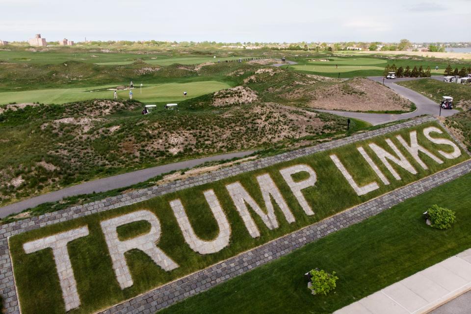 File image: Patrons play the links as a giant branding sign is displayed with flagstones at Trump Golf Links at Ferry Point in the Bronx borough of New York on Tuesday, 4 May, 2021 (AP)