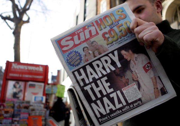 <div class="inline-image__caption"><p>A man reads The Sun in London on Jan. 13, 2005, with a headline about Prince Harry wearing a Nazi uniform at a costume party.</p></div> <div class="inline-image__credit">Jim Watson/AFP via Getty</div>