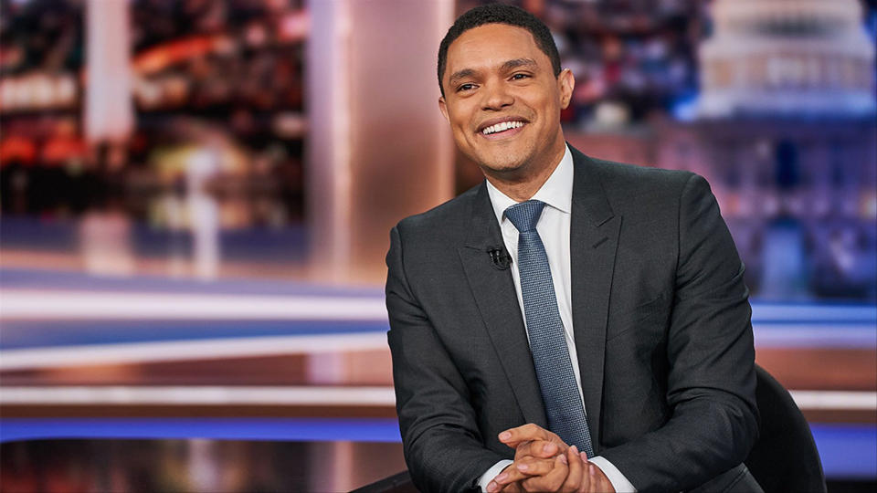 Trevor Noah smiles on set