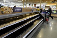 Empty shelves are seen at the Meijer store, Monday, March 16, 2020, in Whitestown, Ind. People concerned with the coronavirus have been shopping ahead and emptying store shelves. (AP Photo/Darron Cummings)