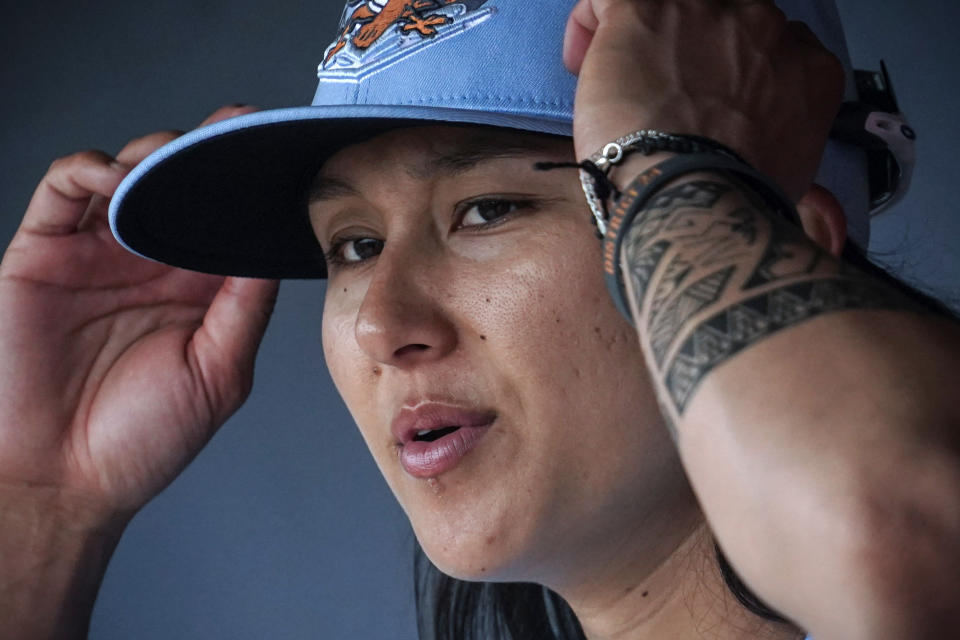 Kelsie Whitmore, a 23-year-old two-way player for the Atlantic League's Staten Island FerryHawks, sits in her team's dugout before gametime, Friday, May 13, 2022, in New York. Whitmore is one of the first women to be in the starting lineup and pitch relief with a professional team connected to Major League Baseball. (AP Photo/Bebeto Matthews)