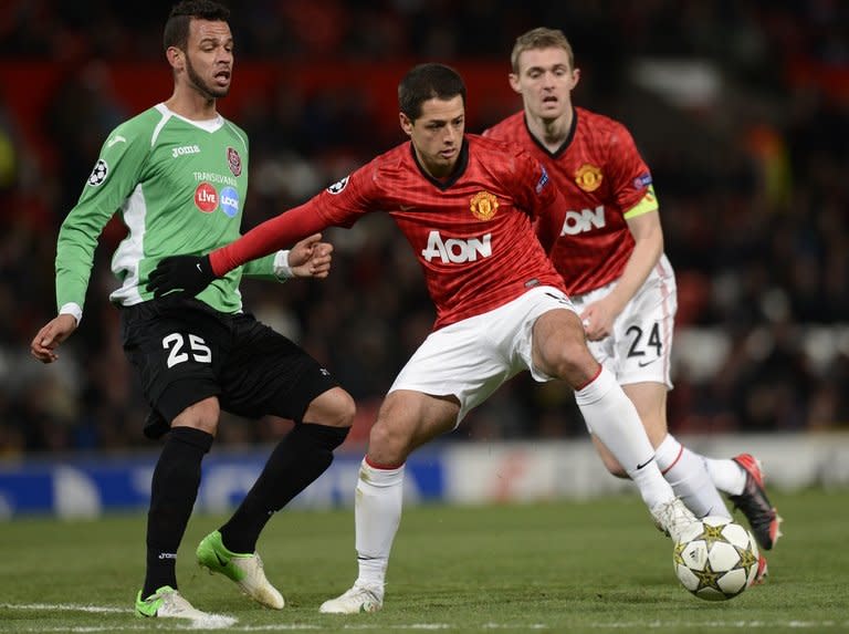 Manchester United's Mexican forward Javier Hernandez (C) holds off Cluj's Brazilian midfielder Luis Alberto. United manager Sir Alex Ferguson insists he has no worries about going into Sunday's Manchester derby on the back of a 1-0 defeat to Champions League minnows Cluj -- United's first home loss in the competition in more than three years