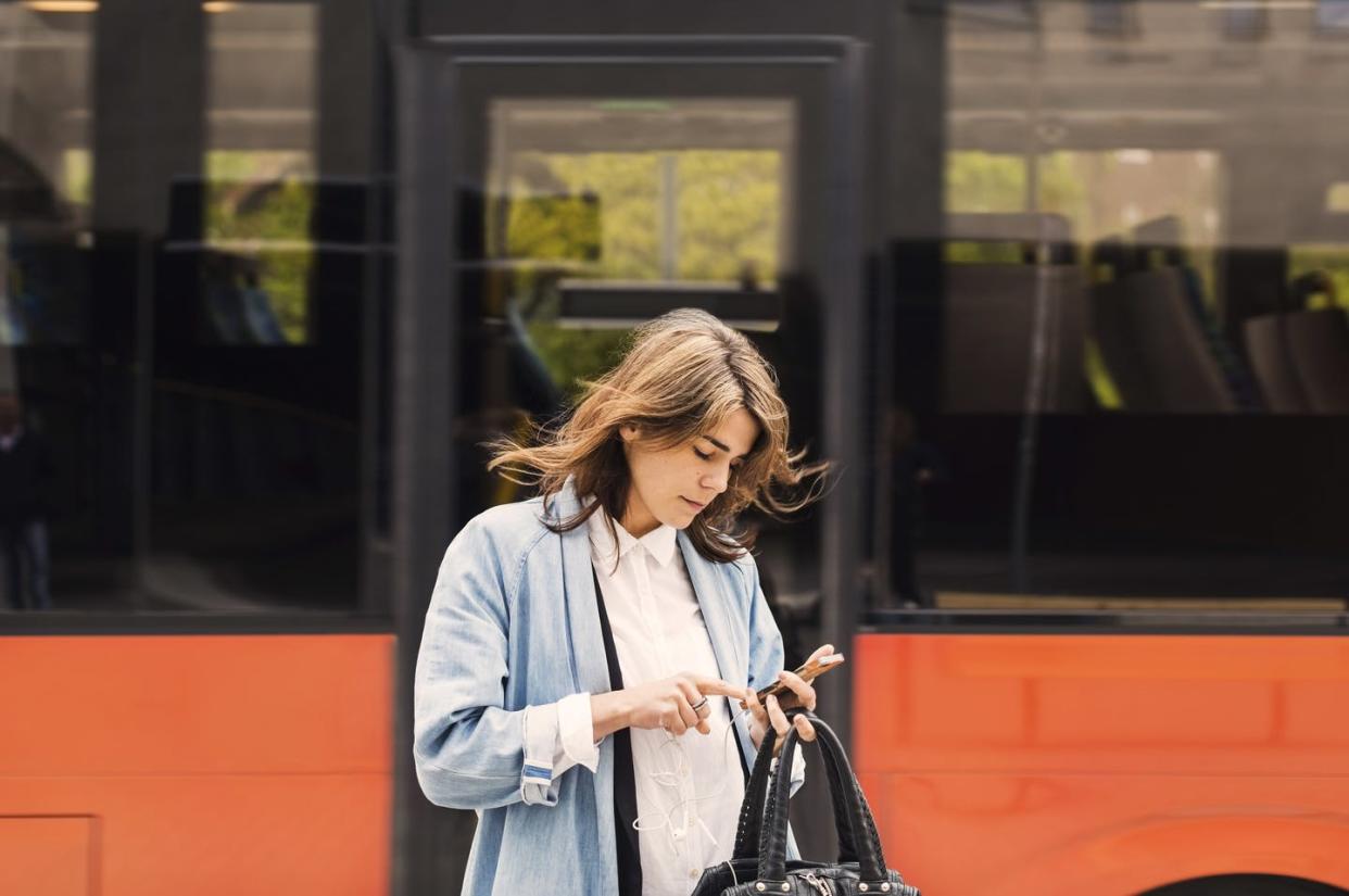 <span class="caption">Where you've been and who you've interacted with are not difficult for governments and corporations to find out.</span> <span class="attribution"><a class="link " href="https://www.gettyimages.com/detail/photo/young-woman-using-mobile-phone-against-bus-royalty-free-image/605380195" rel="nofollow noopener" target="_blank" data-ylk="slk:Maskot via Getty Images;elm:context_link;itc:0;sec:content-canvas">Maskot via Getty Images</a></span>