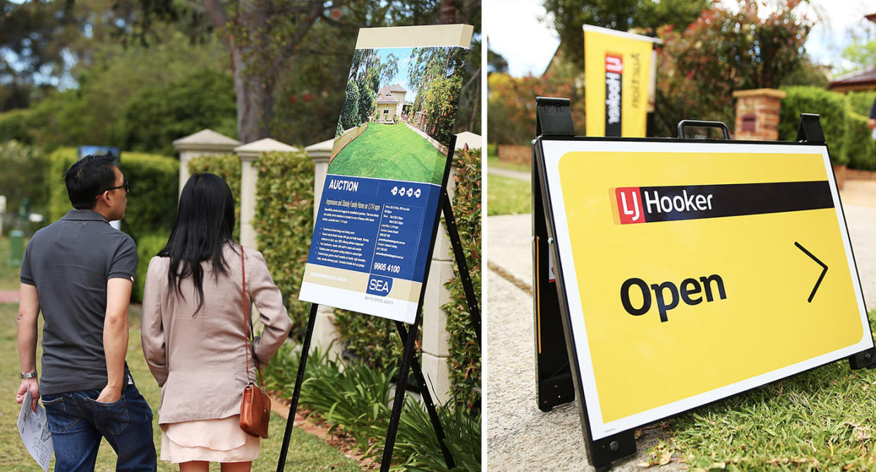 Two people looking at an open home sign.