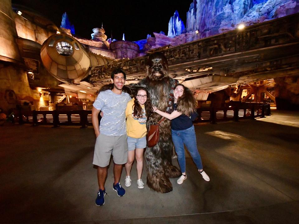sofia and two friends posing with chewbacca in galaxy's edge in disney world