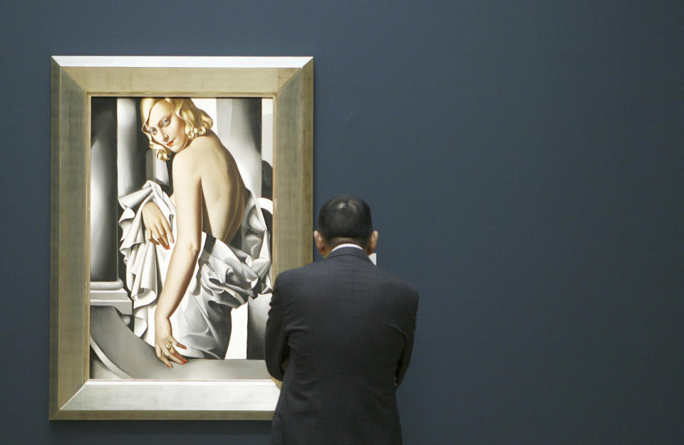 A visitor looks at Tamara de Lempicka's