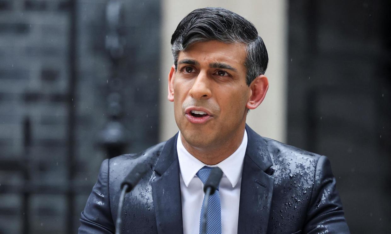 <span>Rishi Sunak braves the weather to announce the 4 July election.</span><span>Photograph: Hollie Adams/Reuters</span>