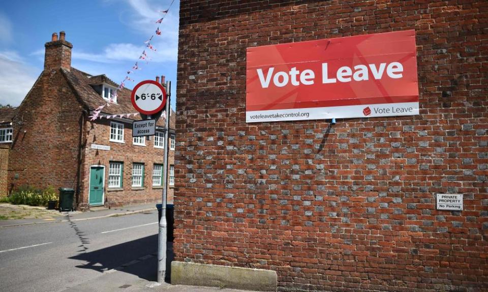 A 'Vote Leave' sign is seen on the side of a building