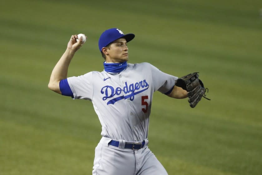 Los Angeles Dodgers shortstop Corey Seager throws to first base as he warms up.