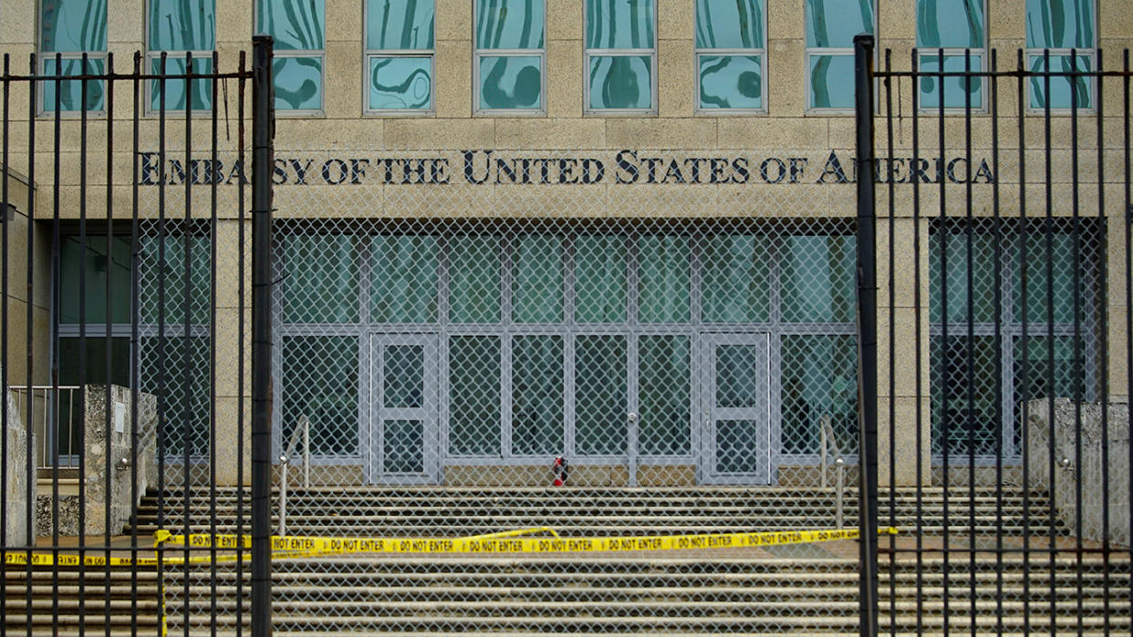 The U.S. Embassy in Havana with a fence and caution tape blocking the entrance.