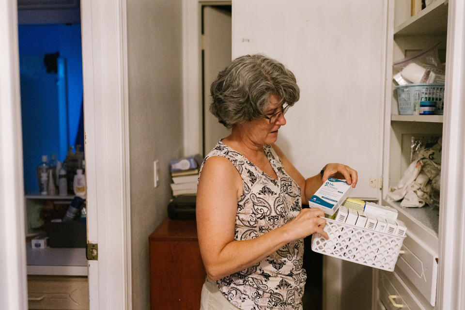 Cynthia Rogers, Ellis's mother, looks through the medicine cabinet in her home to find the morning-after pills she keeps for Ellis and her friends in case of emergencies.<span class="copyright">Morgan Lieberman</span>