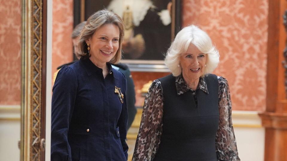 Queen Camilla at Buckingham Palace in black dress and sheer leopard print blouse