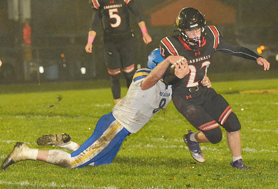 Deuel's Owen Haas attempts to break free from Redfield's Chase McGillivray during their high school football game on Friday, Oct. 13, 2023 in Clear Lake. The fifth-rated Class 11B Cardinals won 50-0.